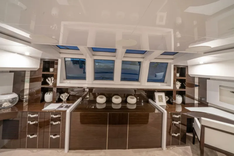  Yacht Photos Pics Luxurious interior of 2020 Pearl 95 yacht with elegant wood finishes and panoramic windows.