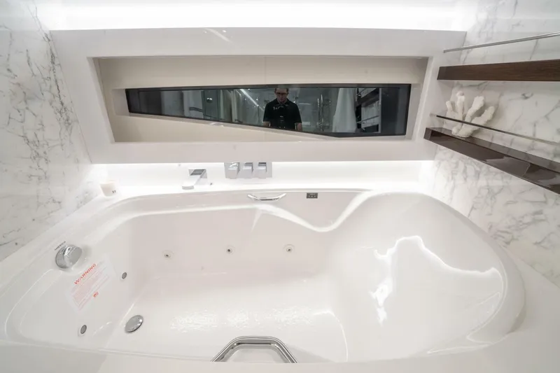  Yacht Photos Pics Luxurious Pearl 95 yacht bathroom with marble accents and modern bathtub, 2020 model.