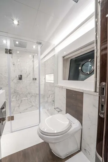  Yacht Photos Pics Luxurious yacht bathroom with marble shower, modern fixtures, and porthole window. Pearl 95, 2020 model.