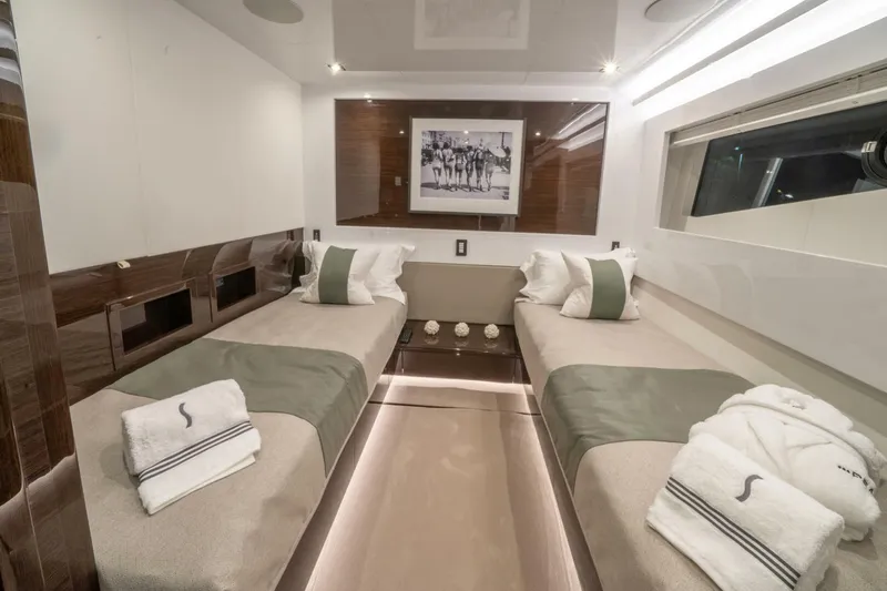 Yacht Photos Pics Luxurious twin cabin interior on 2020 Pearl 95 yacht, featuring elegant decor and plush bedding.
