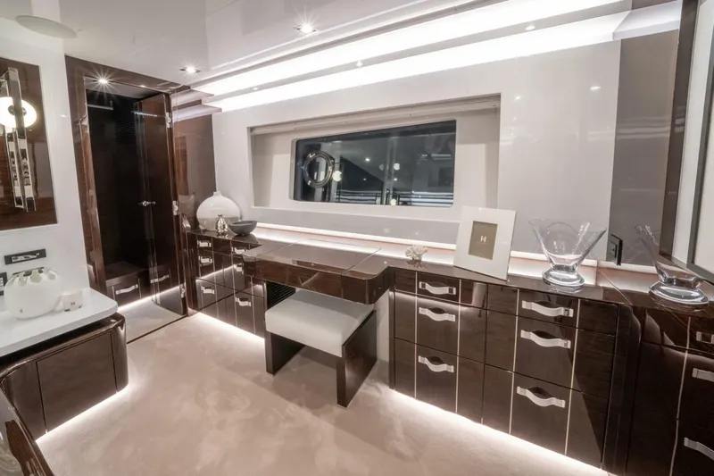  Yacht Photos Pics Luxurious interior of a 2020 Pearl 95 yacht with elegant wood cabinetry and modern lighting.