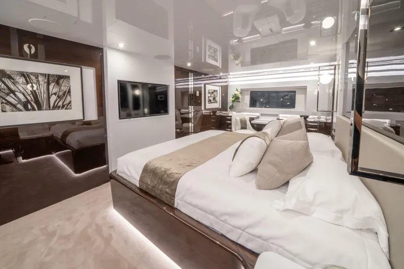  Yacht Photos Pics Luxurious bedroom interior in 2020 Pearl 95 yacht, featuring modern decor and ambient lighting.