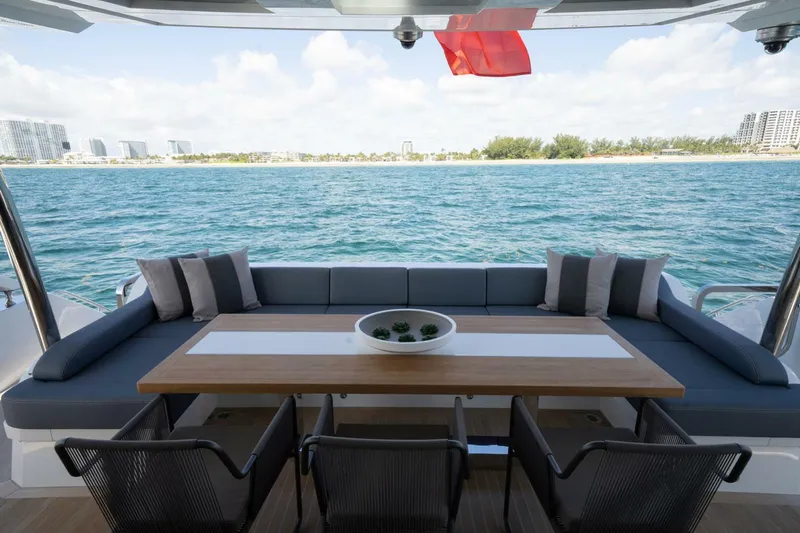  Yacht Photos Pics Luxurious Pearl 95 yacht deck with seating, table, and ocean view, 2020 model.