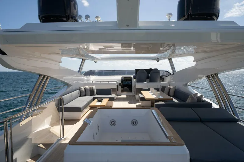  Yacht Photos Pics Luxurious Pearl 95 yacht deck with seating and jacuzzi, 2020 model, on open sea.