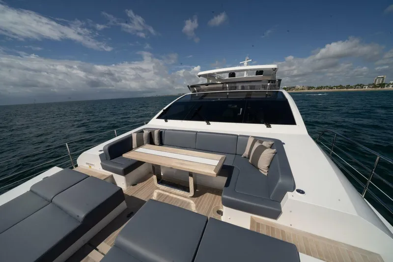  Yacht Photos Pics Luxurious Pearl 95 yacht deck with seating, table, and ocean view, 2020 model.
