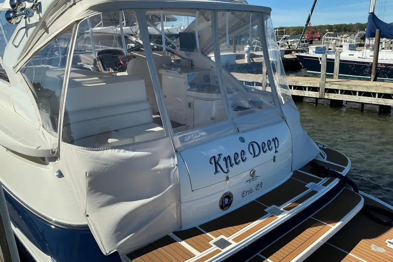 Knee Deep Yacht Photos Pics 2003 Regal Commodore 4260 yacht named "Knee Deep" docked at a marina.