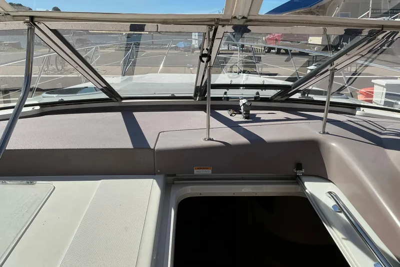 Knee Deep Yacht Photos Pics 2003 Regal Commodore 4260 boat interior with open hatch and windshield view.