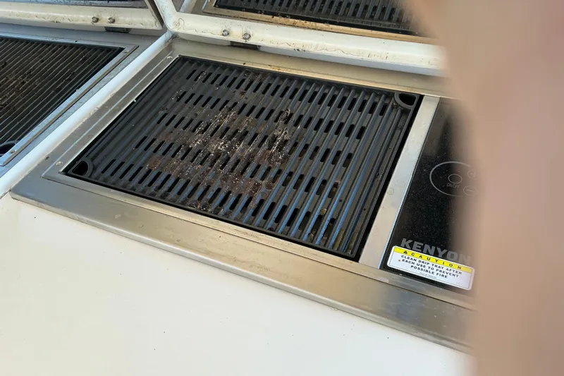 Knee Deep Yacht Photos Pics Built-in Kenyon grill on 2003 Regal Commodore 4260 yacht, featuring a sleek design.