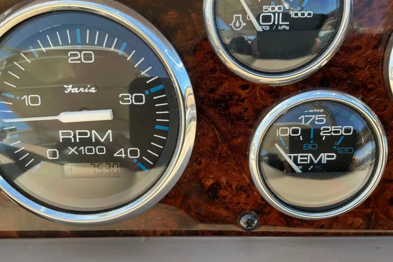Knee Deep Yacht Photos Pics Close-up of 2003 Regal Commodore 4260 dashboard gauges, showing RPM, oil pressure, and temperature.