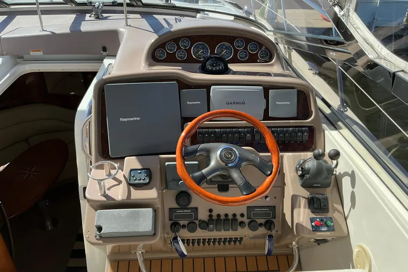 Knee Deep Yacht Photos Pics 2003 Regal Commodore 4260 yacht helm with Raymarine and Garmin navigation systems.