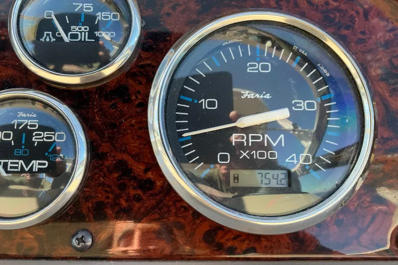 Knee Deep Yacht Photos Pics Close-up of 2003 Regal Commodore 4260 dashboard gauges, showing RPM, oil, and temperature.