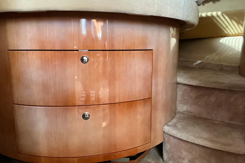 Knee Deep Yacht Photos Pics 2003 Regal Commodore 4260 interior with wooden drawers and carpeted stairs.