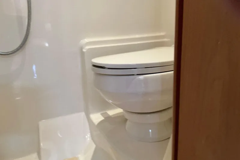 Knee Deep Yacht Photos Pics Bathroom interior of 2003 Regal Commodore 4260 yacht, featuring a compact toilet.