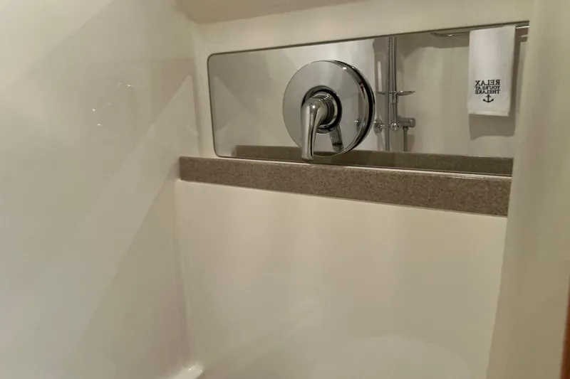Knee Deep Yacht Photos Pics Shower area in 2003 Regal Commodore 4260 yacht with chrome fixtures and towel.