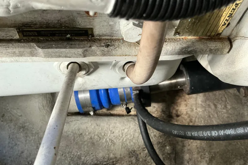 Knee Deep Yacht Photos Pics Engine compartment of a 2003 Regal Commodore 4260 boat, showing pipes and hoses.