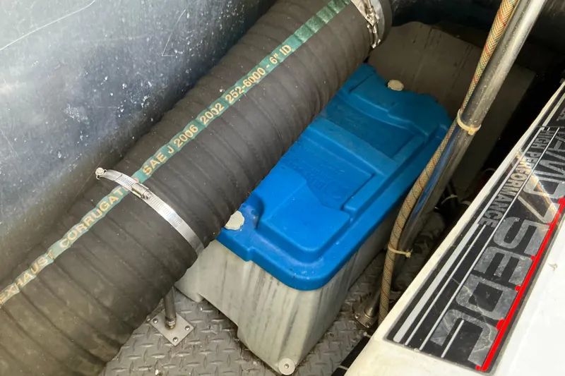 Knee Deep Yacht Photos Pics 2003 Regal Commodore 4260 engine compartment with blue battery and exhaust hose.