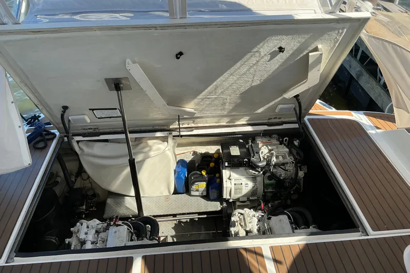 Knee Deep Yacht Photos Pics Open engine compartment of 2003 Regal Commodore 4260 boat, showing mechanical components.