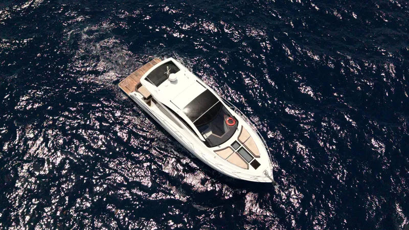 Keep Paddlin Yacht Photos Pics Aerial view of 2019 Galeon 430 HTC yacht cruising on deep blue ocean waters.