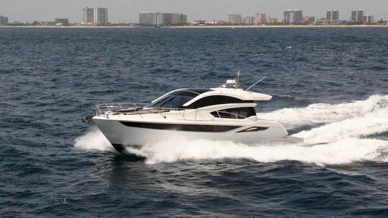 Keep Paddlin Yacht Photos Pics 2019 Galeon 430 HTC yacht cruising on open water near a city skyline.