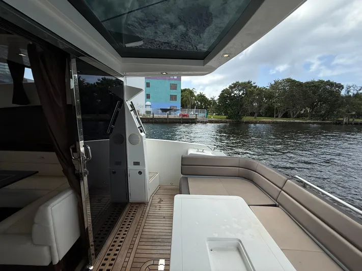 Keep Paddlin Yacht Photos Pics 2019 Galeon 430 HTC yacht interior with open deck, overlooking serene waterfront and lush greenery.