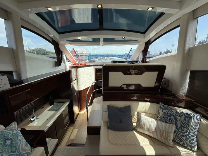 Keep Paddlin Yacht Photos Pics Luxurious interior of 2019 Galeon 430 HTC yacht with elegant seating and modern kitchen amenities.