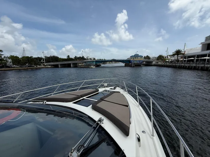 Keep Paddlin Yacht Photos Pics 2019 Galeon 430 HTC yacht cruising through a scenic waterway under a blue sky.