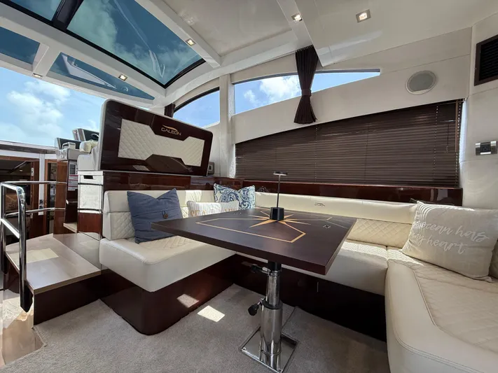 Keep Paddlin Yacht Photos Pics Luxurious interior of 2019 Galeon 430 HTC yacht with plush seating and elegant table.