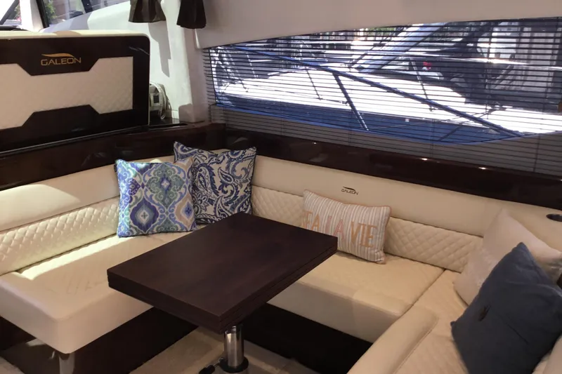 Keep Paddlin Yacht Photos Pics Luxurious interior of 2019 Galeon 430 HTC yacht with elegant seating and decorative pillows.
