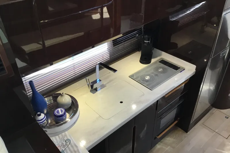 Keep Paddlin Yacht Photos Pics Modern kitchen interior of 2019 Galeon 430 HTC yacht with sleek countertops and appliances.