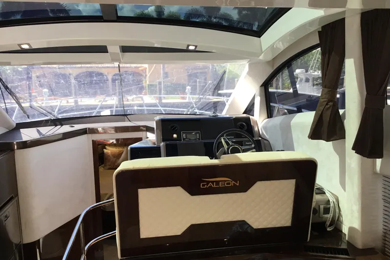 Keep Paddlin Yacht Photos Pics Interior of 2019 Galeon 430 HTC yacht with modern helm and panoramic windows.