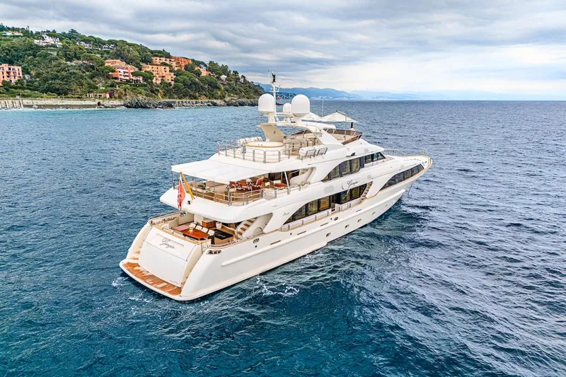 Giorgia I Yacht Photos Pics Luxurious 2009 Benetti Classic 120 yacht cruising near scenic coastline.