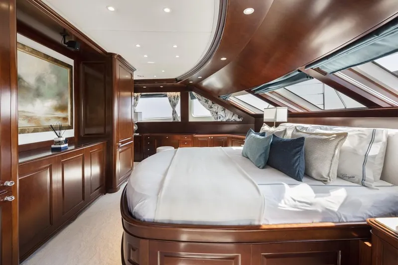 Giorgia I Yacht Photos Pics Luxurious bedroom interior on 2009 Benetti Classic 120 yacht, featuring elegant wood paneling and plush bedding.