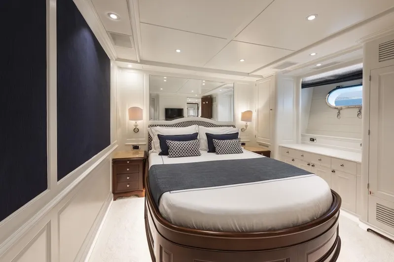 Giorgia I Yacht Photos Pics Luxurious bedroom interior on a 2009 Benetti Classic 120 yacht, featuring elegant furnishings and nautical decor.