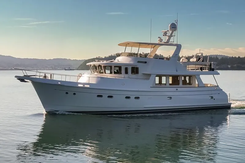 Raindancer Yacht Photos Pics 2009 Selene 60 Ocean Trawler cruising on calm waters at sunset.