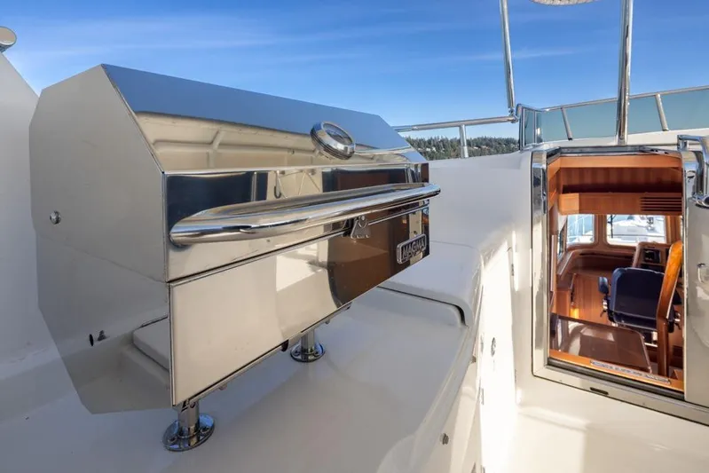 Raindancer Yacht Photos Pics Stainless steel grill on 2009 Selene 60 Ocean Trawler yacht deck, with cabin view.