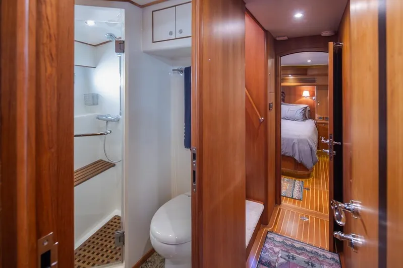 Raindancer Yacht Photos Pics Luxurious interior of 2009 Selene 60 Ocean Trawler with wood paneling and cozy bedroom.