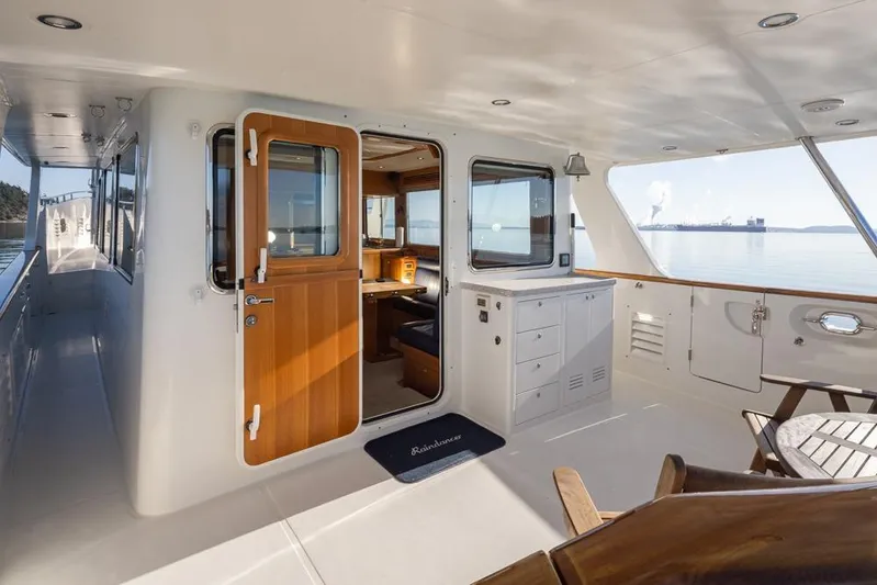 Raindancer Yacht Photos Pics 2009 Selene 60 Ocean Trawler yacht interior with wooden door and seating area.
