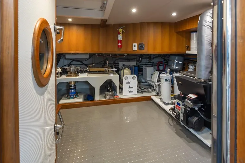 Raindancer Yacht Photos Pics Engine room of 2009 Selene 60 Ocean Trawler with modern equipment and wooden paneling.