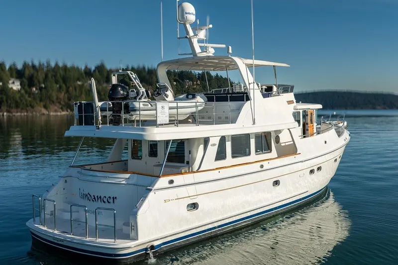 Raindancer Yacht Photos Pics 2009 Selene 60 Ocean Trawler yacht on calm water, featuring a spacious deck and modern design.