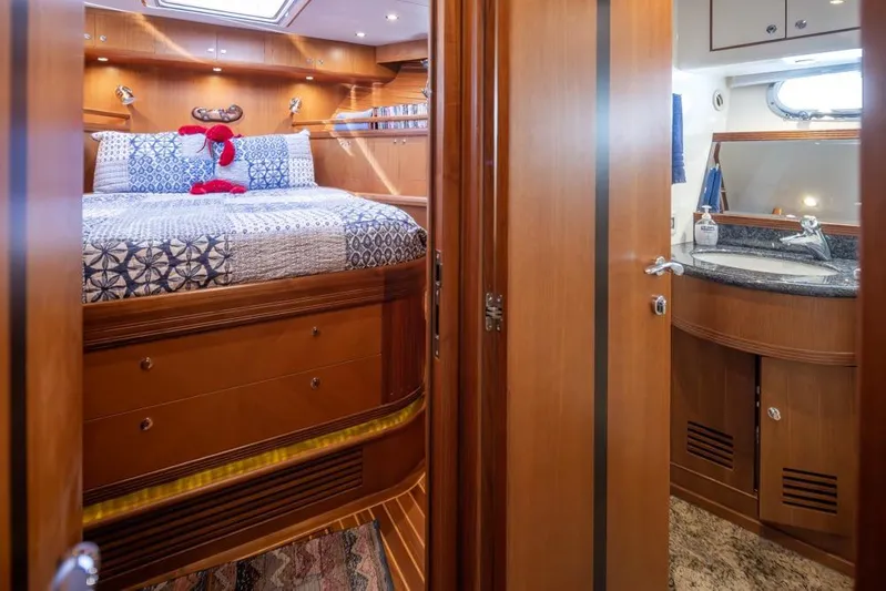Raindancer Yacht Photos Pics Luxurious cabin interior of 2009 Selene 60 Ocean Trawler with cozy bed and ensuite bathroom.