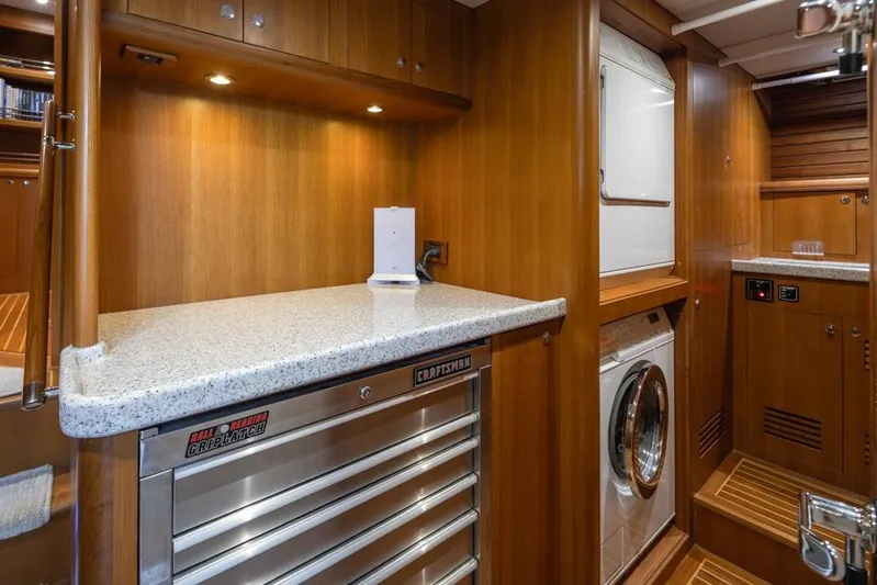 Raindancer Yacht Photos Pics Laundry area in 2009 Selene 60 Ocean Trawler with washer, dryer, and storage cabinets.