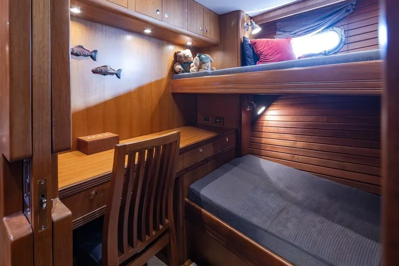 Raindancer Yacht Photos Pics Cozy cabin interior of 2009 Selene 60 Ocean Trawler with wooden bunk beds and desk.