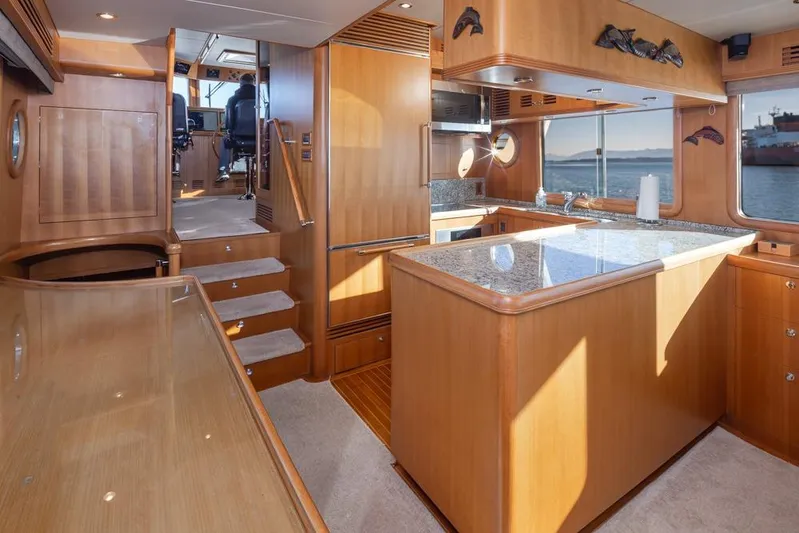 Raindancer Yacht Photos Pics Luxurious 2009 Selene 60 Ocean Trawler interior with elegant wood finishes and modern kitchen.