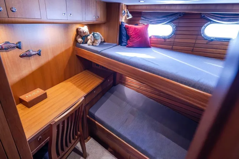 Raindancer Yacht Photos Pics Cozy cabin interior of 2009 Selene 60 Ocean Trawler with bunk beds and wooden desk.