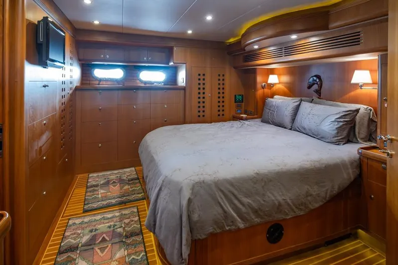 Raindancer Yacht Photos Pics Luxurious cabin interior of 2009 Selene 60 Ocean Trawler with wood paneling and cozy bedding.