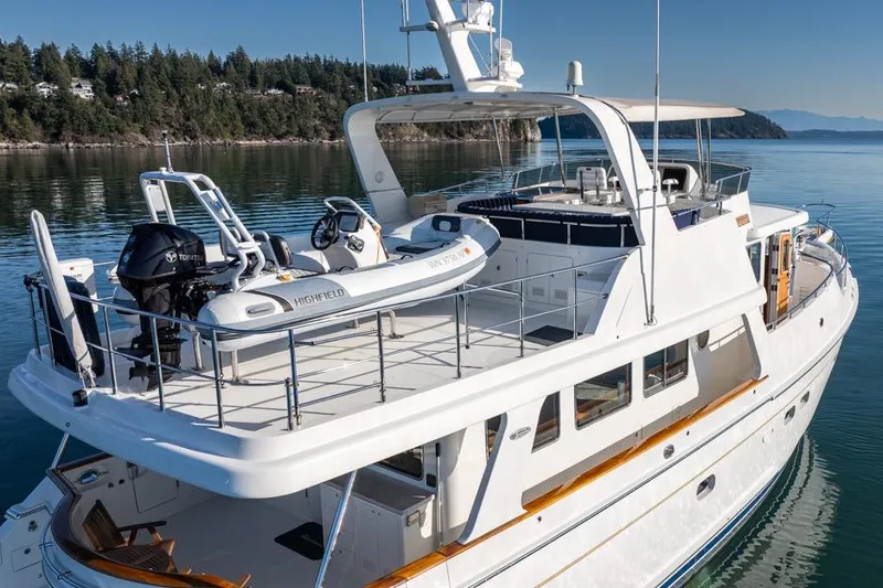 Raindancer Yacht Photos Pics 2009 Selene 60 Ocean Trawler yacht with tender, docked in serene waters.