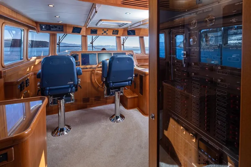 Raindancer Yacht Photos Pics Luxurious 2009 Selene 60 Ocean Trawler helm with dual captain chairs and navigation equipment.