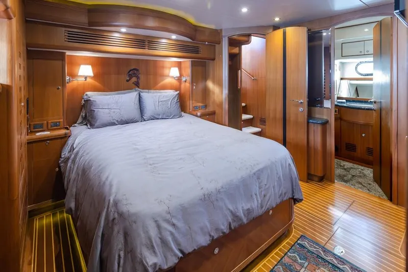 Raindancer Yacht Photos Pics Luxurious bedroom interior of 2009 Selene 60 Ocean Trawler yacht with wooden finishes.
