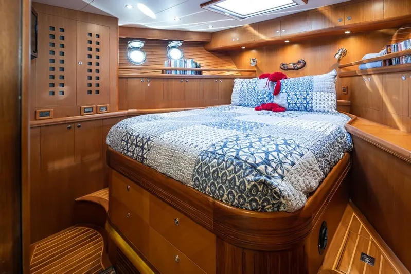 Raindancer Yacht Photos Pics Luxurious cabin interior of 2009 Selene 60 Ocean Trawler with wood paneling and cozy bedding.