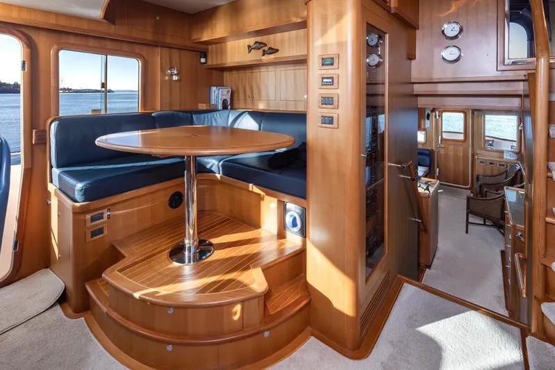 Raindancer Yacht Photos Pics Luxurious 2009 Selene 60 Ocean Trawler interior with wood finish and blue seating.